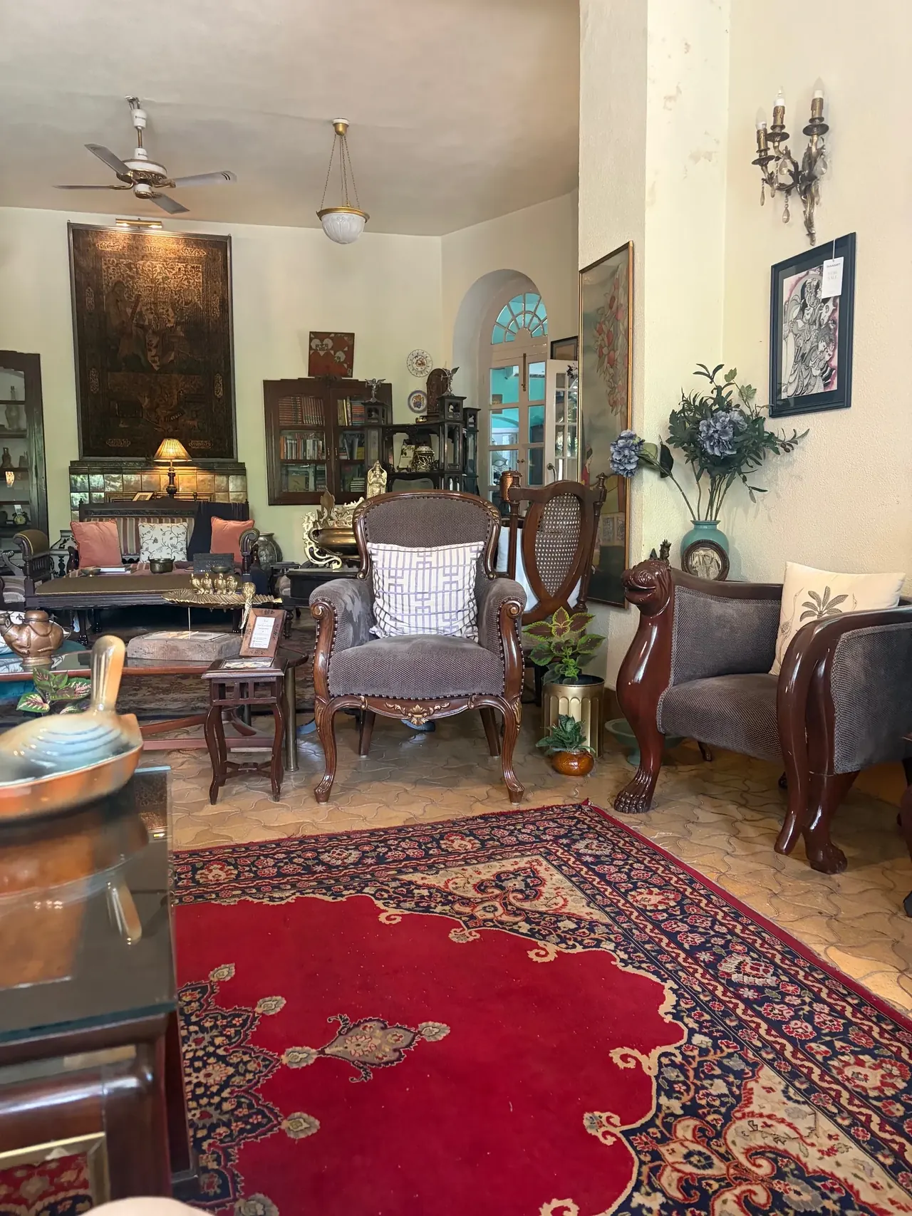 Antique-furnished living room with carved chairs and a Persian rug, heritage ancestral property Amritsar tour