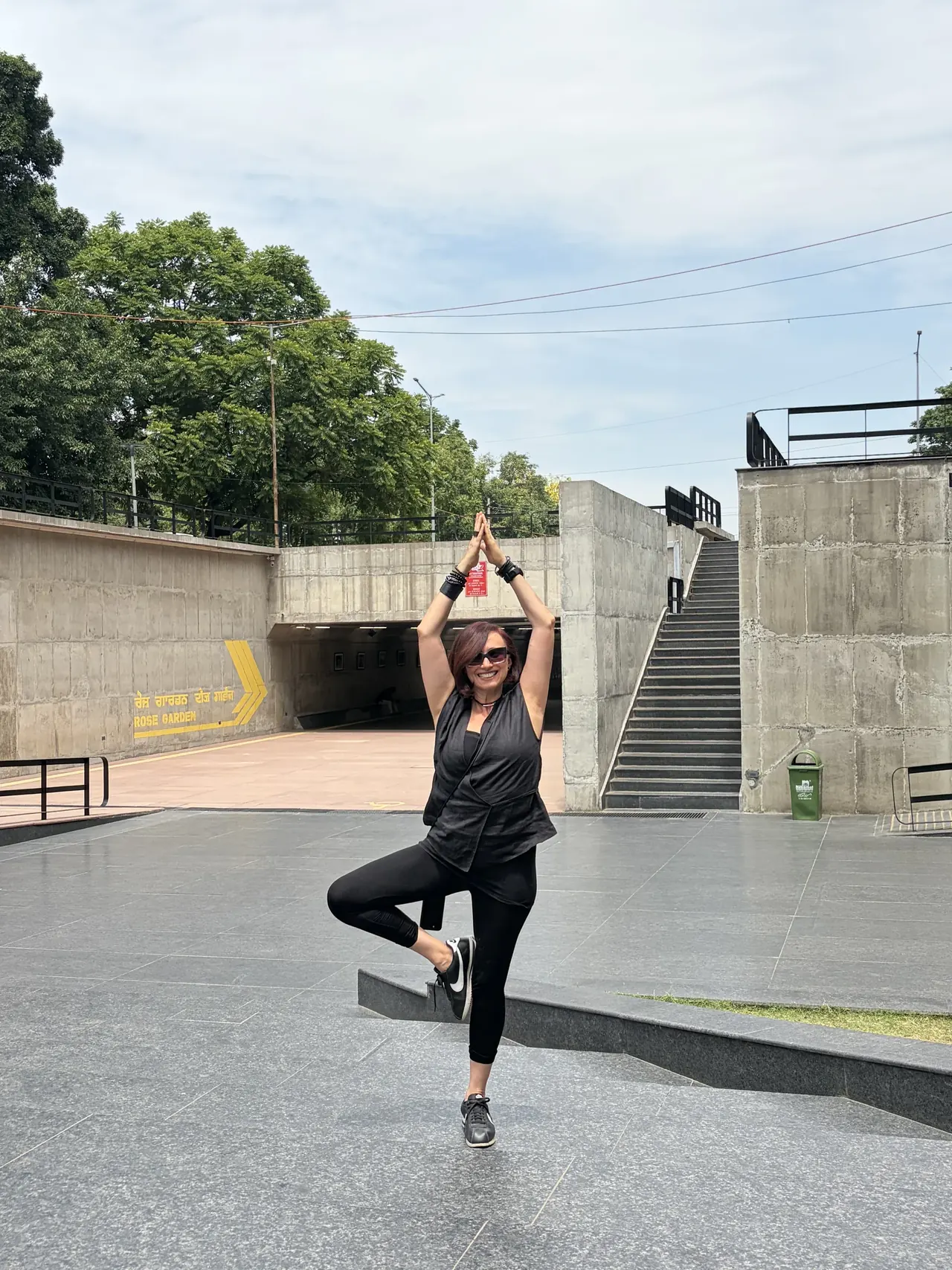 Visitor in a yoga pose at the Sector 17 plaza near the Rose Garden underpass, Chandigarh tour