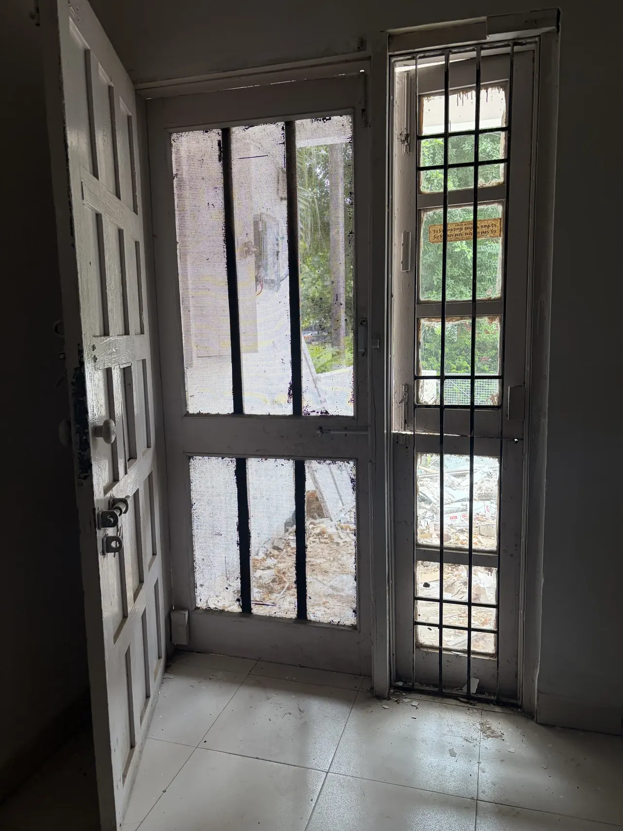 View through the door and window grille of a Socialist Housing unit, Chandigarh Le Corbusier design tour