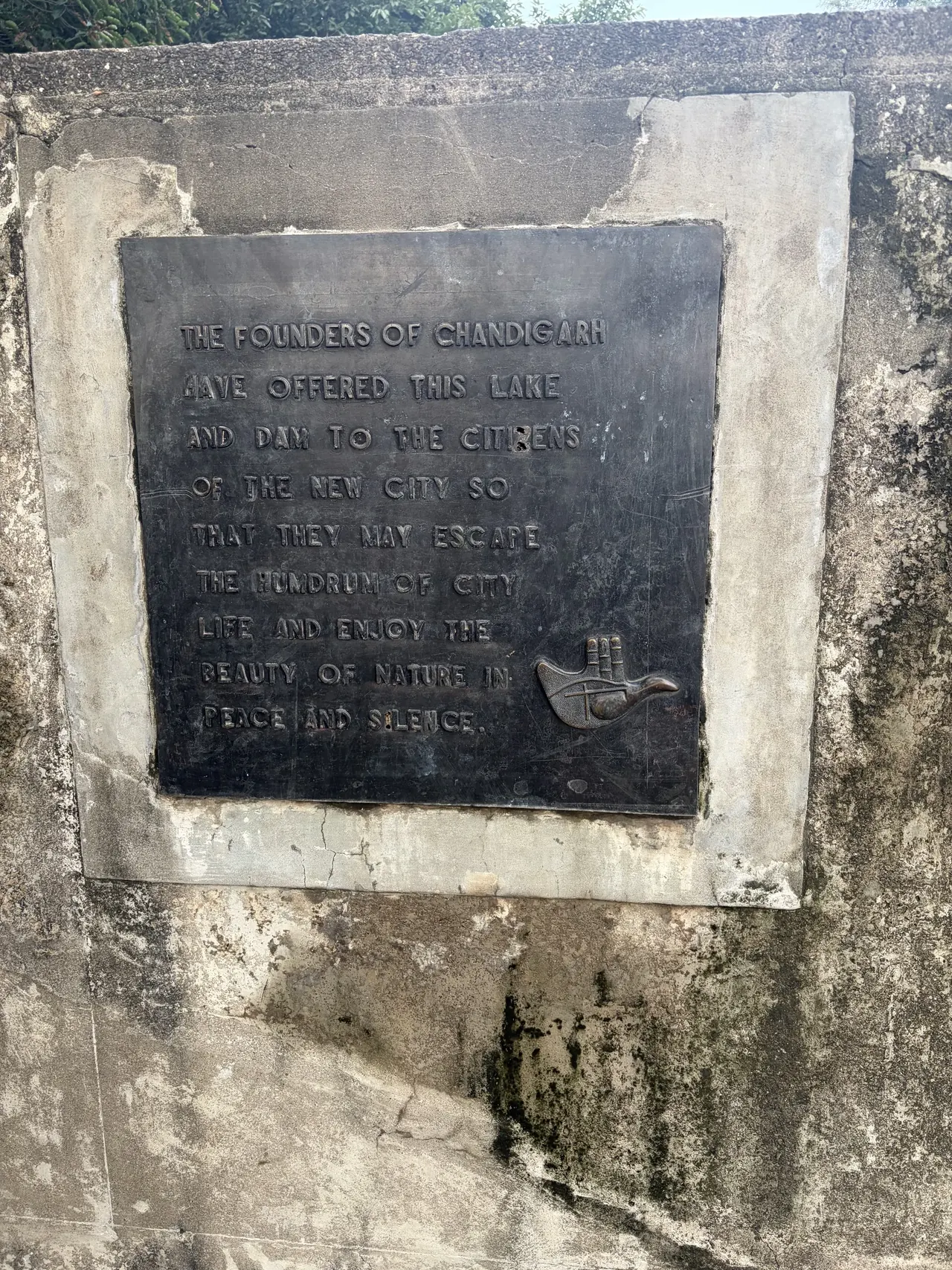 Bronze founders plaque with the Open Hand emblem at Sukhna Lake, Le Corbusier Chandigarh design tour