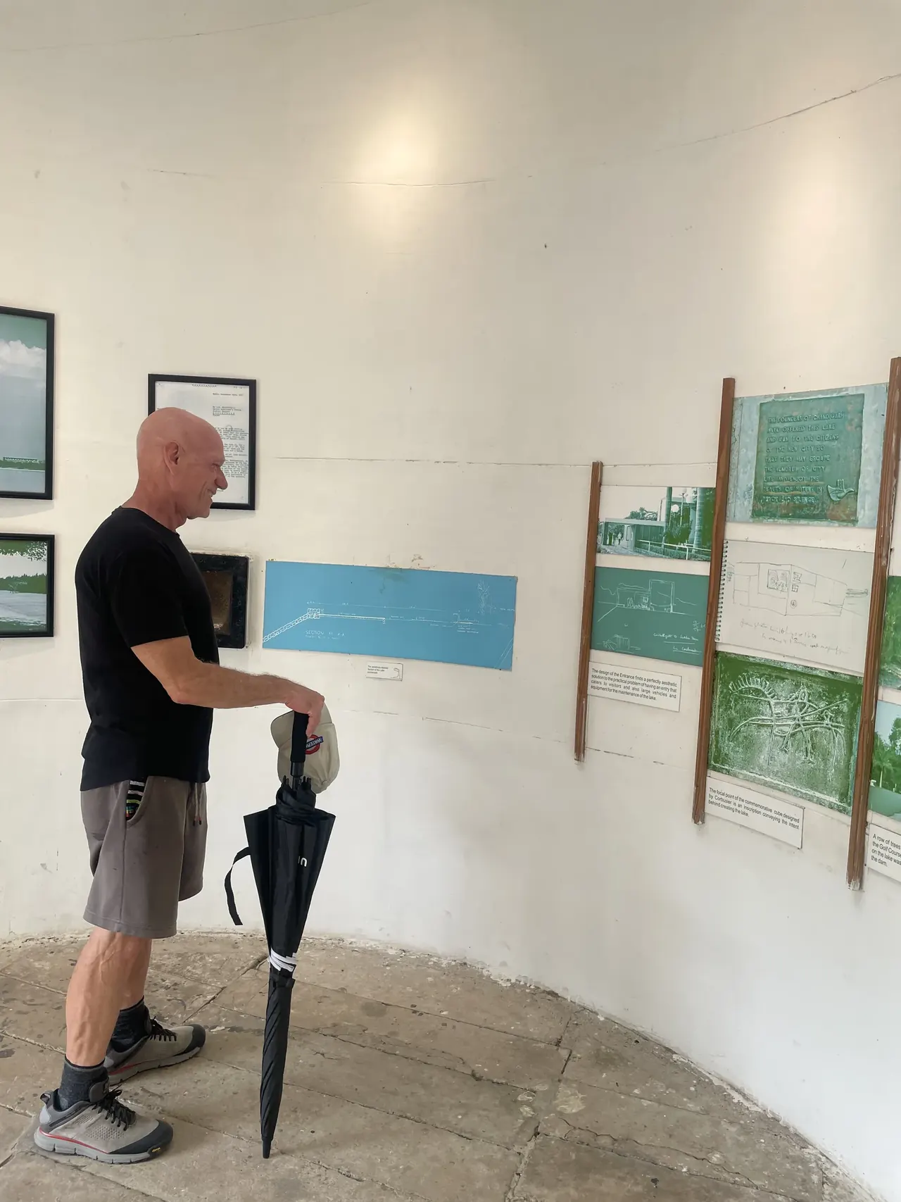 Visitor reading exhibits inside the Sukhna Lake interpretation room, Le Corbusier design tour Chandigarh